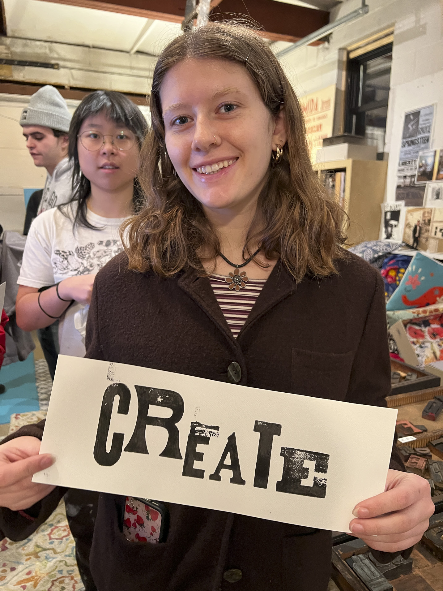 Tisch student holding a print made with hand-set type